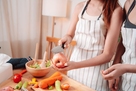 Young Women Asian Food Cooking Preparation Salad Vegetable Kitchen Lifestyle Healthy Eating, Joyful Moments of Healthy Meal Making and Togetherness in a Cozy Home Kitchen Full of Freshness and Smilesの写真素材