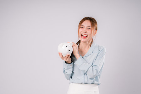 Woman Saving Money Save Bank Happy Finance Invest Profit Deposit, Young Woman Smiling Brightly While Saving and Investing Wisely, Celebrating Financial Growth and a Confident Step Toward Successの写真素材