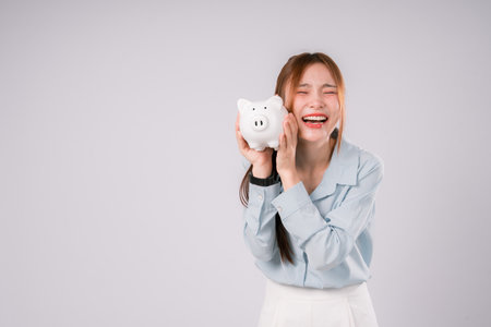 Woman Saving Money Save Bank Happy Finance Invest Profit Deposit, Young Woman Smiling Brightly While Saving and Investing Wisely, Celebrating Financial Growth and a Confident Step Toward Successの写真素材