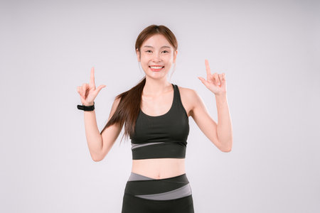Fitness Exercise Woman White Portrait Female Background Activewear Posing Fit, Confident and Energetic Female Athlete Embracing a Healthy Lifestyle On White Backgroundの写真素材
