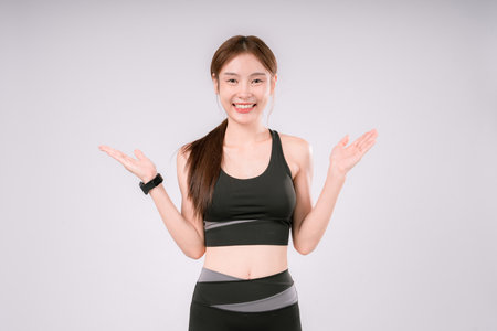 Fitness Exercise Woman White Portrait Female Background Activewear Posing Fit, Confident and Energetic Female Athlete Embracing a Healthy Lifestyle On White Backgroundの写真素材