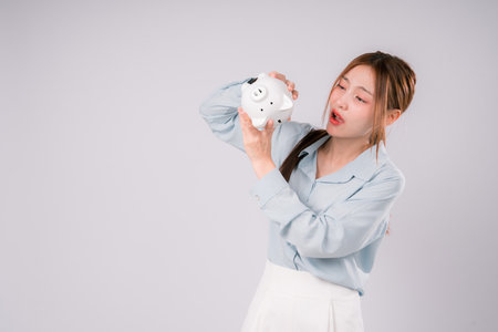 Woman Saving Money Save Bank UnHappy Finance Invest Profit Deposit, Young Woman Smiling Brightly While Saving and Investing Wisely, Celebrating Financial Growth and a Confident Step Toward Successの写真素材