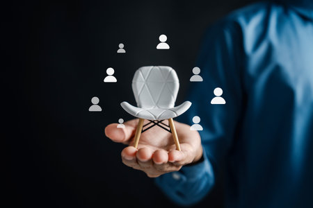 Recruitment with white chair and magnifying glass icons, symbolizing online job applications, candidate selection, and hiring process in digital organizations.の写真素材