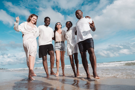 Happy diverse group of friends together on the beach, Active friendship, summer fun, positivity, and...