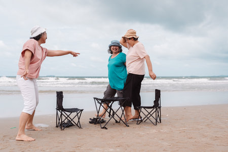 Asian senior females walking on the beach, smiling and enjoying retirement freedom. healthy senior lifestyle.の写真素材