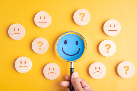 Focus blue smile face among mixed emotions on yellow background, focusing on happiness, mental health, and positive emotional direction.の写真素材