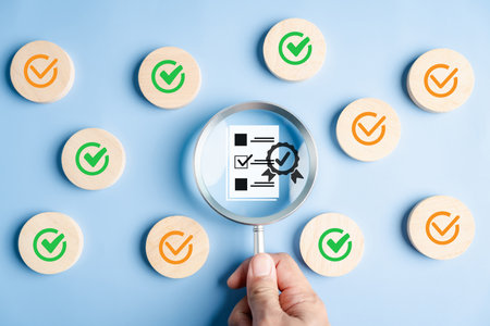 Document check and certificate approval with magnifying glass on checklist and verified badge, quality assurance, compliance, standard validation, and certification.の写真素材