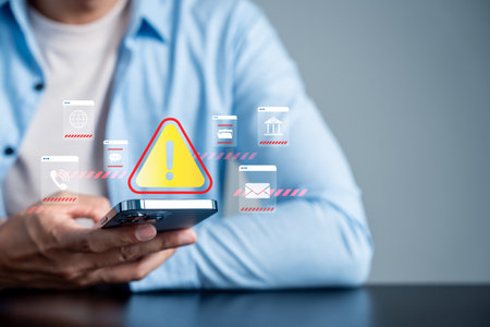 System warning and cybersecurity alert concept on smartphone. Digital risk management and data protection notification for online security, malware threat prevention, and network safety awareness.の写真素材