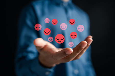 Anger and negative emotions with red angry face icons floating in digital space. mental health issues, stress, emotional control, and psychological challenges.の写真素材