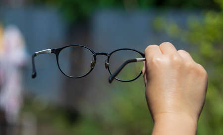 hand holding eyeglasses