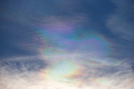 Rainbow colors in the blue sky with white clouds, abstract background - blue sky with Fire Rainbowの写真素材