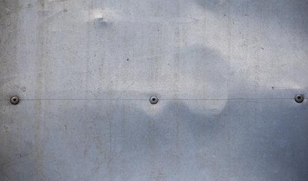 Stainless steel texture background with rivets, closeup of photo