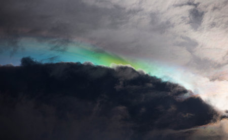 Rainbow in the dark sky with dark clouds, natural background.の写真素材