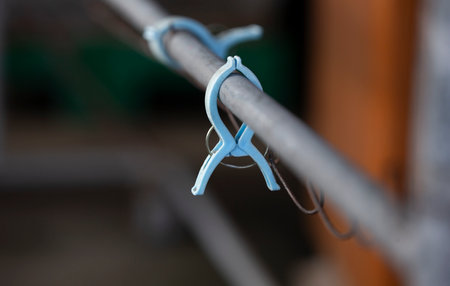 Clothes pegs on a clothesline in a public place.
