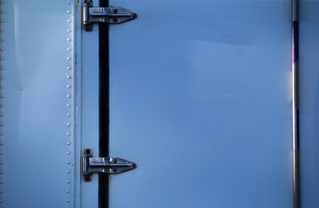 Detail of a blue metal door with lock and keyhole.の写真素材