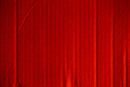 Red corrugated cardboard sheet useful as a background - retro styleの写真素材