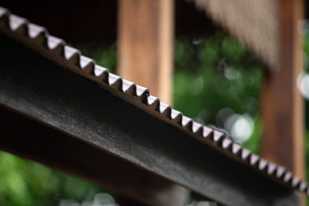 Close up of a metal saw blade on a wooden fence. Selective focus.