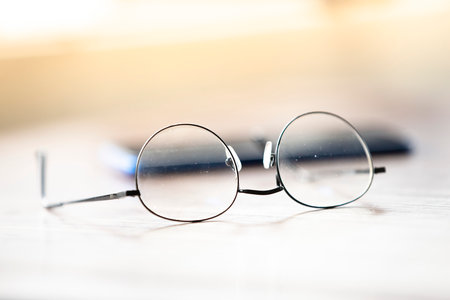 Eyeglasses on the table. Selective focus and shallow depth of field.の写真素材