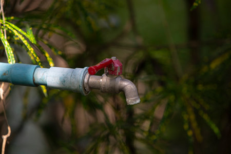 Water tap with faucet in the garden. Selective focus.の写真素材