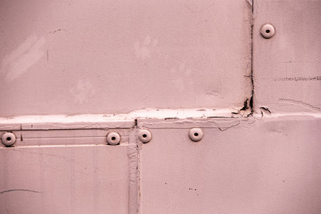 Old metal background with rivets and screws, closeup of photoの写真素材