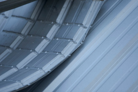 Close up of metal roofing tiles in construction site. Building materials.