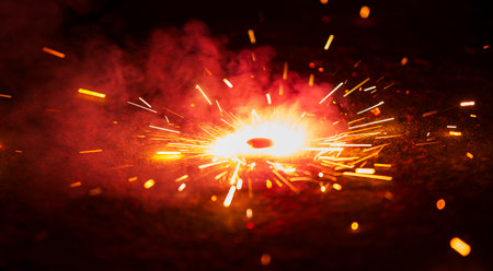 sparks from firework with sparks on a black background close upの写真素材