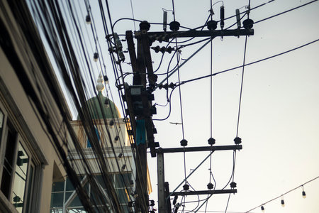 Silhouette of electric pole in the city,  Thailand.