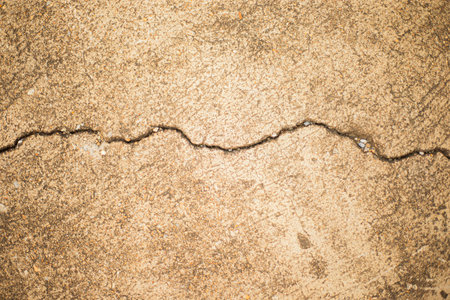 Cracks on the concrete floor. Abstract background and texture for design.