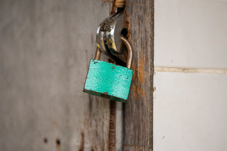 Old padlock on the wooden door, closeup of photo.の写真素材