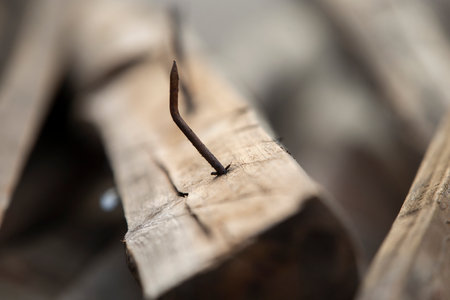 rusty nail in wood, macro shot, shallow depth of fieldの写真素材