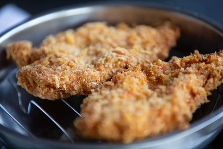 Fried chicken in a pan, close-up, selective focus