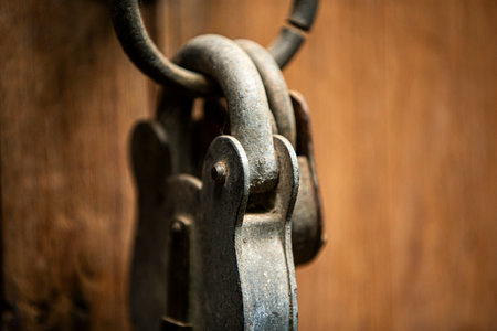Old rusty padlock on a wooden door. Shallow depth of field.