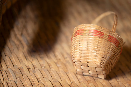 basket made of bamboo on a wicker background, close upの写真素材