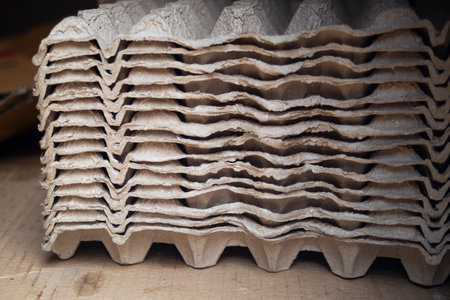 Stack of cardboard boxes on a wooden table.