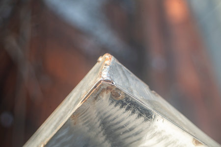 close-up of a metal sheet on a blurred background of a windowの写真素材