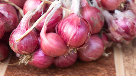 Shallot onions on wooden background. Shallow depth of field.
