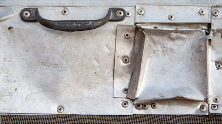 Close-up of a white metal plate with rivets and screwsの写真素材