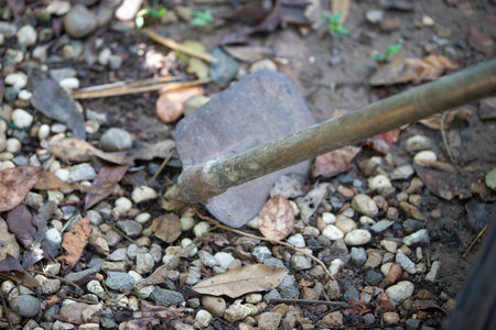Shovel and pebbles in the garden, selective focus