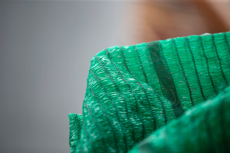 Closeup of green fabric on a gray background. Selective focus.の写真素材