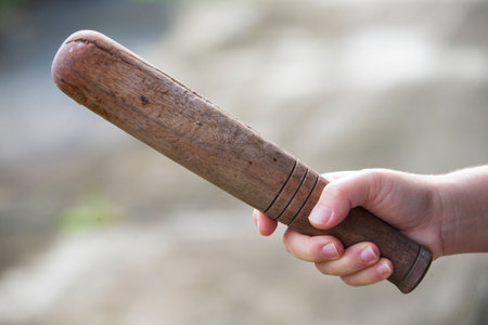 Hand holding a Pestle. Selective focus with shallow depth of field.の写真素材