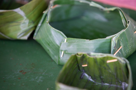 Thai dessert made from glutinous rice wrapped in banana leaf.の写真素材