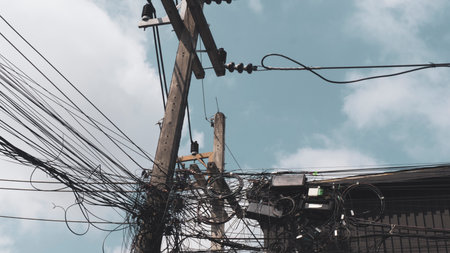 electricity post with many cables and wiresの写真素材