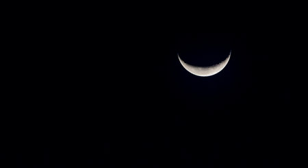 Crescent moon in the night sky. Close up of the moon.の写真素材