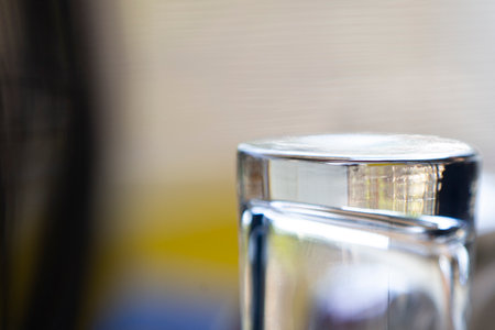 Close up of a glass of water in a room with a blurred backgroundの写真素材