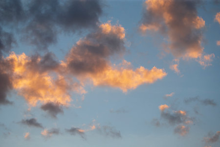 Cloudscape, Colored Clouds at Sunset near the Ocean on a Blue Sky