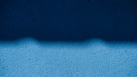 Blue wall with shadow from the sun. Abstract background and texture for design.の写真素材