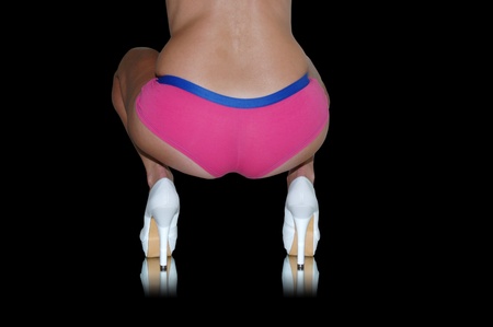 female backside wearing pink boy shorts and white high heeled pumps.の写真素材