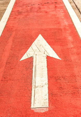 Arrow red  signs as road markings on a street