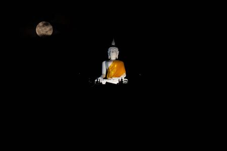 White buddha The top of the hill in the dark with the moonの写真素材