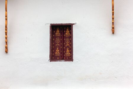 vintage windows on the white wall at Luang phabangの写真素材